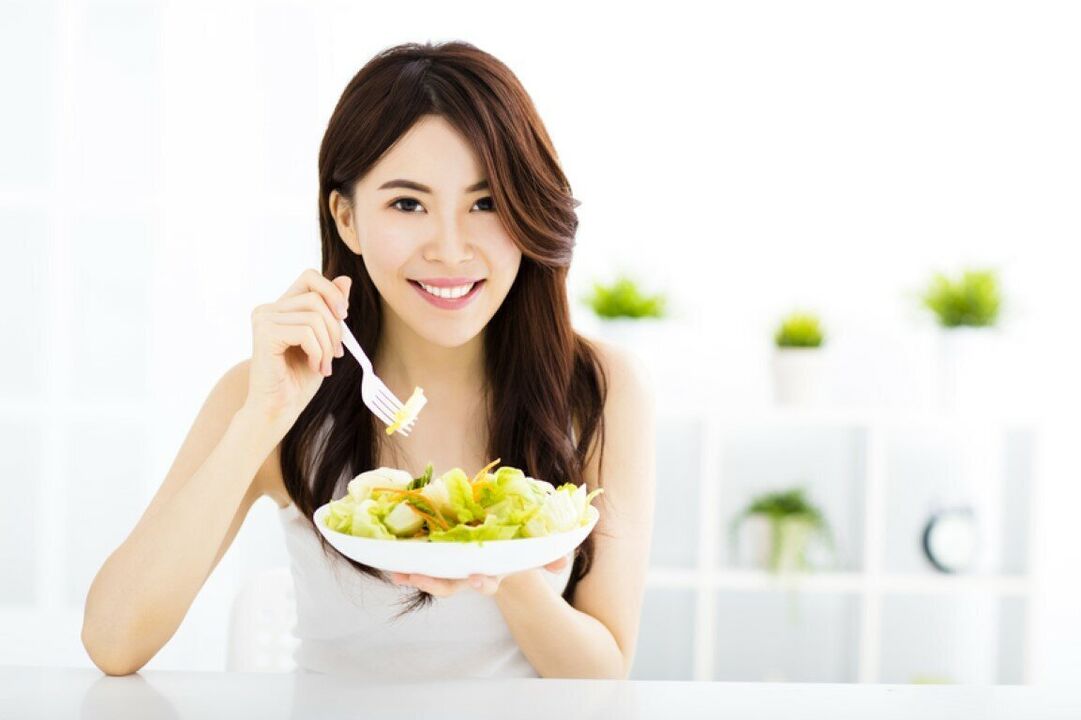 Japanese woman eats a salad